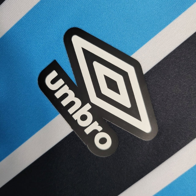 Camisa Grêmio I 23/24 -  Umbro Feminina - Azul com listras pretas e brancas