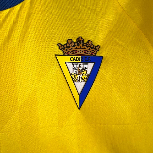 Kit Infantil Cadiz I Macron 23/24 - Amarelo com detalhes em azul
