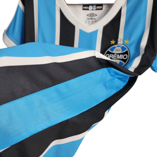 Camisa Grêmio I 23/24 -  Umbro Feminina - Azul com listras pretas e brancas